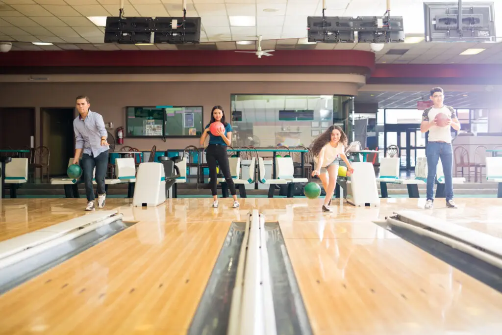 Friends playing at bowling lanes